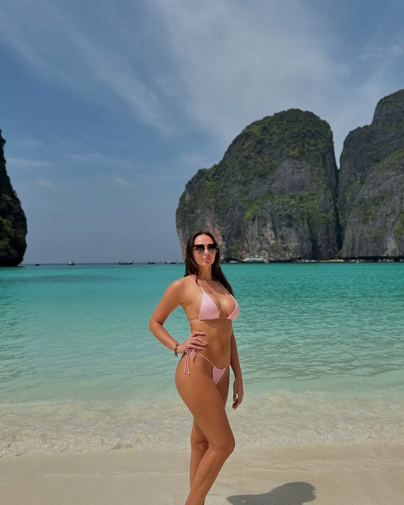 Woman in a pink Malibu diamante bikini by opulence in Thailand