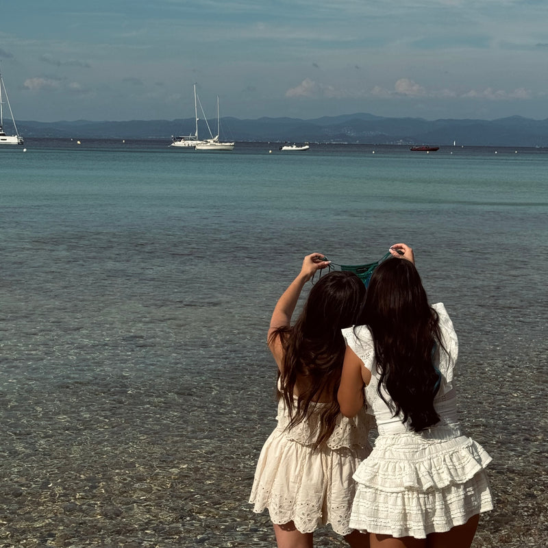 Founder of By Opulence holding a bikini in the south of France