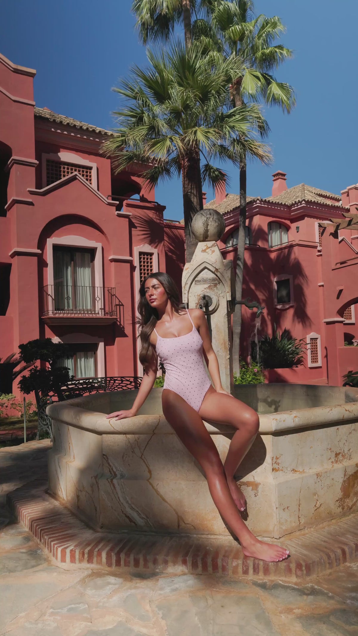 By Opulence Blush Pink Diamanté Swimsuit Product Video. Model wears baby pink swim costume with silver rhinestones.